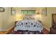 Comfortable bedroom featuring natural light and a patterned bedspread on a well-made bed at 2713 Mcdowell Rd, Durham, NC 27705