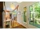 Bright entryway featuring hardwood floors and modern lighting, flowing into a kitchen with a breakfast bar at 2713 Mcdowell Rd, Durham, NC 27705