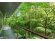 Scenic exterior view of a tree-lined property from a long covered deck at 2713 Mcdowell Rd, Durham, NC 27705