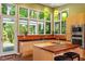 Modern kitchen with stainless steel appliances, a central island, and large windows overlooking a wooded area at 2713 Mcdowell Rd, Durham, NC 27705