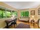 Comfortable living room with a large windows, desk, and hardwood floors at 2713 Mcdowell Rd, Durham, NC 27705