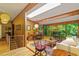Open-concept living and dining area with wood accents, large windows, and stylish furnishings at 2713 Mcdowell Rd, Durham, NC 27705