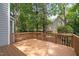 Wooden back deck surrounded by lush greenery and trees at 3008 Isabella Dr, Raleigh, NC 27603