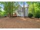 View of home from backyard with a deck, bay window, fenced yard, and lush trees at 3008 Isabella Dr, Raleigh, NC 27603
