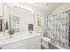 Bathroom with white vanity, decorative shower curtain, and neutral colored walls at 3008 Isabella Dr, Raleigh, NC 27603