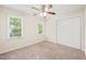 Well-lit bedroom with double closet and views of greenery from windows at 3008 Isabella Dr, Raleigh, NC 27603