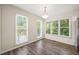Bright dining area with large windows offering scenic outdoor views at 3008 Isabella Dr, Raleigh, NC 27603