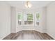Bright dining area featuring a large bay window and new wood flooring at 3008 Isabella Dr, Raleigh, NC 27603
