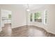 Bright dining area featuring a large bay window and new wood flooring at 3008 Isabella Dr, Raleigh, NC 27603