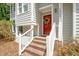 Close-up view of a home's entrance with a red door and brick steps at 3008 Isabella Dr, Raleigh, NC 27603