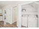 Laundry room with white washer and dryer, and additional shelving at 3008 Isabella Dr, Raleigh, NC 27603