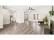 Open-concept living room with french doors, fireplace, and wood-look floors at 3008 Isabella Dr, Raleigh, NC 27603