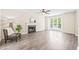 Bright living room with a fireplace, large windows, and sleek flooring at 3008 Isabella Dr, Raleigh, NC 27603