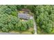 Aerial view of property featuring mature trees surrounding the home and driveway at 313 Shetland Rd, Rougemont, NC 27572