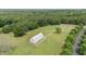 Aerial view of barn surrounded by fields and trees, offering a serene countryside setting at 313 Shetland Rd, Rougemont, NC 27572