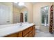 Bathroom featuring single vanity, shower/tub combo, and large window with blinds at 313 Shetland Rd, Rougemont, NC 27572