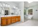 Bright bathroom featuring double vanity, a soaking tub, frameless shower and tile floors at 313 Shetland Rd, Rougemont, NC 27572