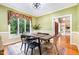 Formal dining room with wainscoting, a modern table and chairs, and large windows at 313 Shetland Rd, Rougemont, NC 27572