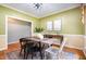 Inviting dining room with a rustic wooden table, stylish chairs, and wainscoting at 313 Shetland Rd, Rougemont, NC 27572