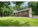 Charming brick home surrounded by mature trees and a well-maintained lawn in a serene setting at 313 Shetland Rd, Rougemont, NC 27572