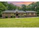 Charming one-story brick home with beautiful landscaping and a well-manicured lawn at 313 Shetland Rd, Rougemont, NC 27572