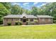 Beautiful brick home with a welcoming front entrance, lush landscaping, and a well-manicured lawn at 313 Shetland Rd, Rougemont, NC 27572