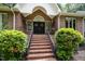 Elegant brick home featuring a grand entrance with double doors, brick steps and manicured landscaping at 313 Shetland Rd, Rougemont, NC 27572
