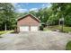 Brick two-car garage with a concrete driveway and landscaping at 313 Shetland Rd, Rougemont, NC 27572