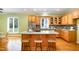 Well-equipped kitchen with wooden cabinets, granite countertops, and a central island with seating at 313 Shetland Rd, Rougemont, NC 27572