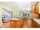 Bright kitchen featuring custom wood cabinets, granite countertops, an island cooktop and hardwood floors at 313 Shetland Rd, Rougemont, NC 27572