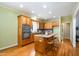 Well-lit kitchen with a large island, wooden cabinets, stainless steel appliances and hardwood flooring at 313 Shetland Rd, Rougemont, NC 27572