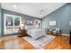 Spacious main bedroom with ample natural light, a ceiling fan, and hardwood floors at 313 Shetland Rd, Rougemont, NC 27572