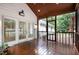 Inviting screened porch features wood flooring, ceiling fan, and access to outdoor living spaces at 313 Shetland Rd, Rougemont, NC 27572