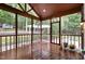 Relaxing screened porch with wood floors, a ceiling fan, and views of the backyard at 313 Shetland Rd, Rougemont, NC 27572