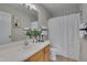 Bathroom featuring a vanity with modern fixtures, and a shower with white curtain and white towels at 314 Virens Dr, Cary, NC 27511