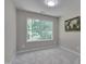 Bedroom featuring neutral carpeting, a ceiling light, a window, and neutral paint at 314 Virens Dr, Cary, NC 27511