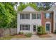 Charming two-story townhouse with white siding, black shutters, and a well-maintained front yard at 314 Virens Dr, Cary, NC 27511