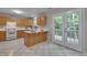 Spacious kitchen leading to a deck through French doors, with plentiful cabinet space and checkered floors at 314 Virens Dr, Cary, NC 27511