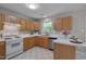 Well-lit kitchen with wood cabinets, white countertops, stainless steel appliances, and checkered floors at 314 Virens Dr, Cary, NC 27511