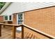 Back porch shows a brick exterior wall and wooden railing at 3517 Morningside Dr, Raleigh, NC 27607