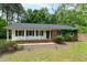 Attractive single-story home with white siding, black shutters, and a well-manicured lawn in a suburban setting at 3517 Morningside Dr, Raleigh, NC 27607