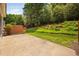 Spacious backyard boasts a concrete patio and lush lawn with mature trees and landscaping at 3619 Lion Ridge Ct, Raleigh, NC 27612