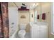 Well-lit bathroom showcases decorative towels, fixtures, cabinets, and a charming lizard art piece at 3619 Lion Ridge Ct, Raleigh, NC 27612