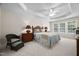 Bright bedroom features soft decor and tray ceiling with ceiling fan at 3619 Lion Ridge Ct, Raleigh, NC 27612