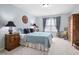 Cozy bedroom features soft blue walls, natural light, and classic wood furniture at 3619 Lion Ridge Ct, Raleigh, NC 27612
