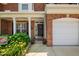 Charming brick home featuring a welcoming front door, well-manicured landscaping, and a two-car garage at 3619 Lion Ridge Ct, Raleigh, NC 27612