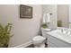 Cozy half bathroom with a white vanity, classic fixtures, and neutral wall color at 3619 Lion Ridge Ct, Raleigh, NC 27612