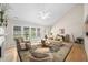 Bright living room with vaulted ceilings, large windows, and a decorative rug at 3619 Lion Ridge Ct, Raleigh, NC 27612