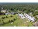 Aerial view of a property with golf course, pool, tennis courts and expansive landscape at 3816 Dover Rd, Durham, NC 27707