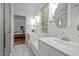 Well-lit bathroom featuring double sinks and a connecting doorway to the bedroom at 3816 Dover Rd, Durham, NC 27707